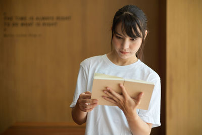 Young woman reading book