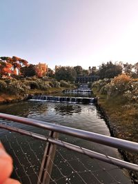 Scenic view of river against clear sky during autumn