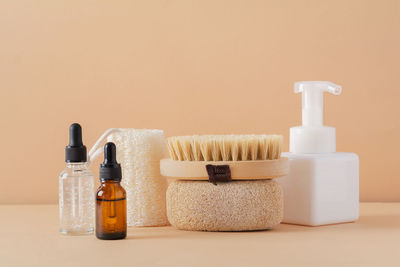 Spa cosmetic products and eco friendly bathroom accessories on a beige background. 