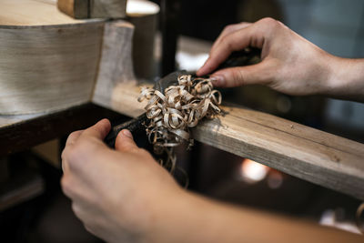 Unrecognized luthier woman in traditional workshop