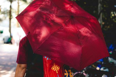 Rear view of woman with red umbrella