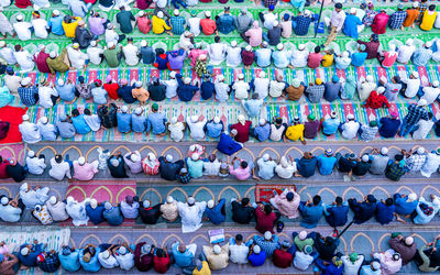 High angle view of men praying outdoors