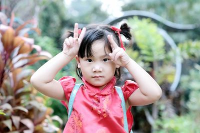 Portrait of cute girl standing outdoors