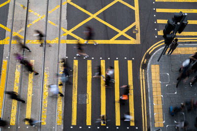 High angle view looking at blurred people crossing the road