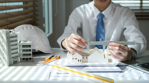 Midsection of scientist working in laboratory