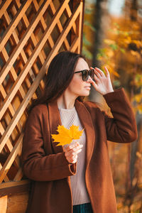 Midsection of woman holding ice cream standing outdoors