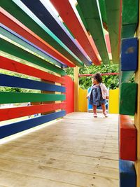 Baby girl walking on playground equipment