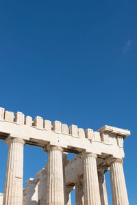 Low angle view of acropolis against clear sky during sunny day