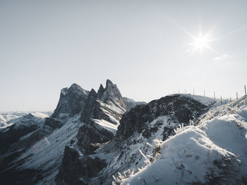 Scenic view of snowcapped mountains against clear sky