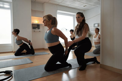 Group of women practicing pilates exercises in class