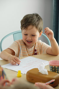 Kids having fun at home by the table, creating hand made art. children drawing and communicating on