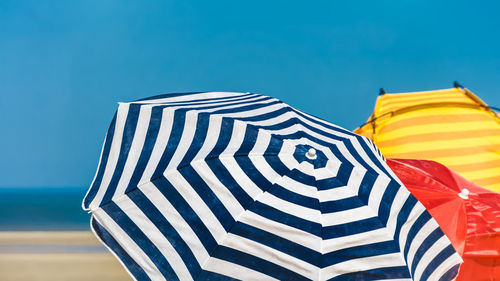 Scenic view of flag against clear blue sky