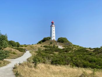 Lighthouse by sea against clear blue sky, hiddensee