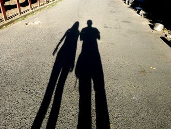 Shadow of people on road