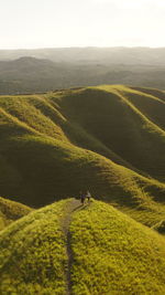 Mid distance of women walking on hill