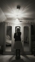 Rear view of a boy standing in corridor