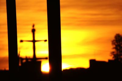 Close-up of silhouette metal against sky during sunset