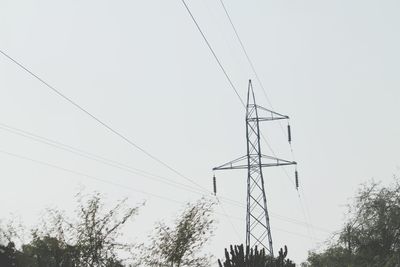 Low angle view of electricity pylon against sky