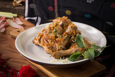 Close-up of grilled chicken on plate on table