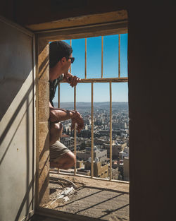 Man looking through window