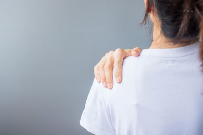 Rear view of woman standing against white background