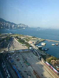 High angle view of city by sea against sky