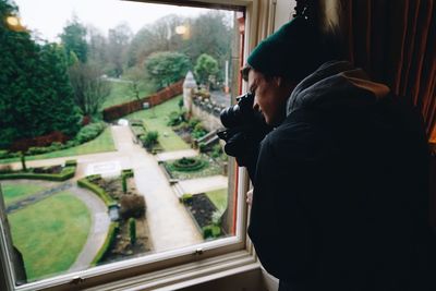 Photographer photographing garden from hotel window