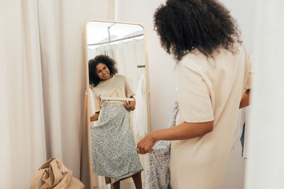 Smiling woman shopping at clothing store