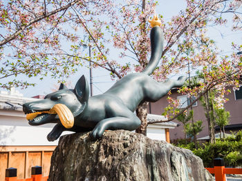 Low angle view of statue against trees