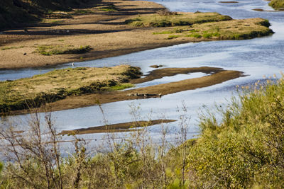 Scenic view of river by landscape