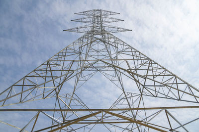 Low angle view of electricity pylon against sky