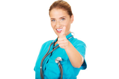 Doctor showing thumbs up against white background