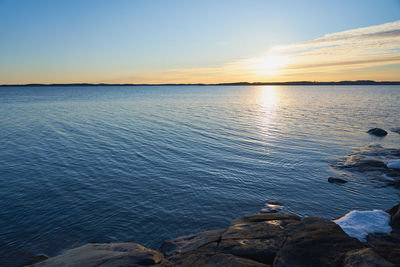 Scenic view of sea against sky at sunset