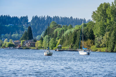 A view of the shoreline at gene coulon park with boat anchored in front.