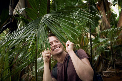 Portrait of man holding plant