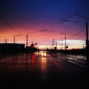 Reflection of electricity pylon against sky during sunset