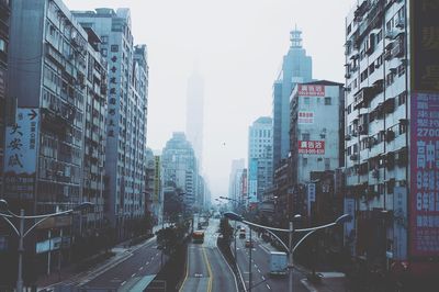 High angle view of street amidst buildings in foggy weather