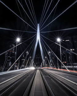 Light trails on road against sky at night