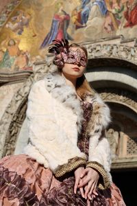 Low angle view of woman wearing costume in church during carnival