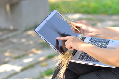 Midsection of woman holding mobile phone