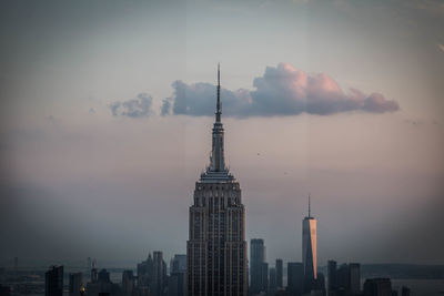 Buildings in city against sky during sunset