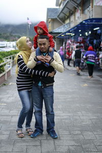 Family on footpath in city