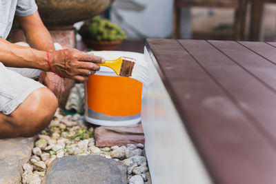 Cropped hands of man holding food on table