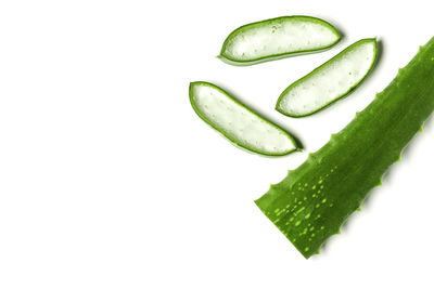 High angle view of green beans against white background