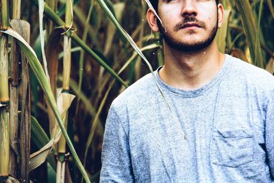 Midsection of man standing by plants