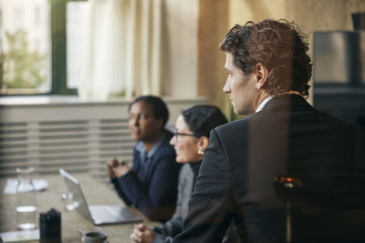 Side view of business colleagues working in office