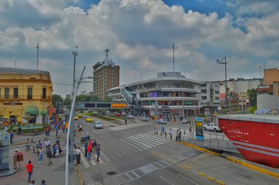 Panoramic view of people in city against sky