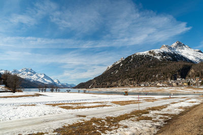 Silvaplana, switzerland, february 21, 2023 winter landscape scenery with a frozen lake of silvaplana