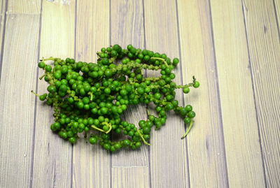 Bunch of green peppercorn on wooden table background