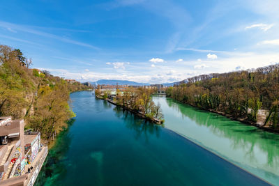 High angle view of swimming pool by river against sky